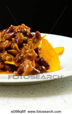 Chilli con carne on nachos View Large Photo Image Stock Image - Chilli con carne on nachos. Fotosearch