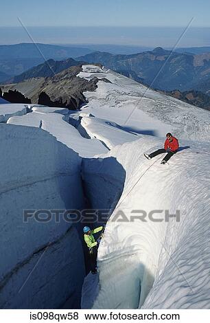 Stock Photo - Climbers on crevasse wall at coleman glacier. Fotosearch
