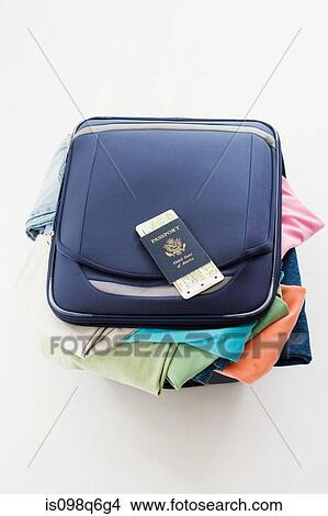 Clothes stuffed in a suitcase View Large Photo Image Picture - Clothes stuffed in a suitcase. Fotosearch
