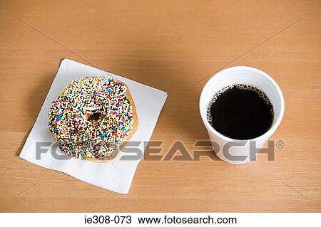 Stock Image - Coffee and a doughnut. Fotosearch
