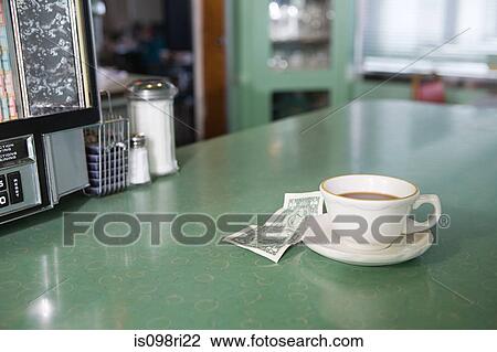 Coffee and money on a diner counter View Large Photo Image Stock Image - Coffee and money on a diner counter. Fotosearch