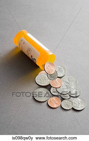 Coins spilling from medicine bottle View Large Photo Image Stock Photo - Coins spilling from medicine bottle. Fotosearch