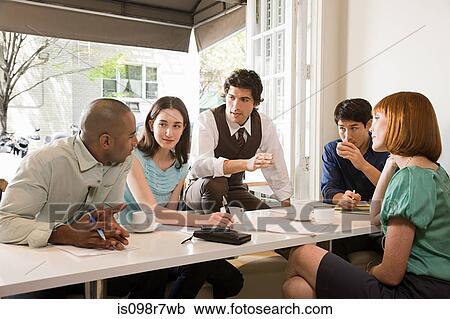 Colleagues meeting in a cafe View Large Photo Image Stock Image - Colleagues meeting in a cafe. Fotosearch