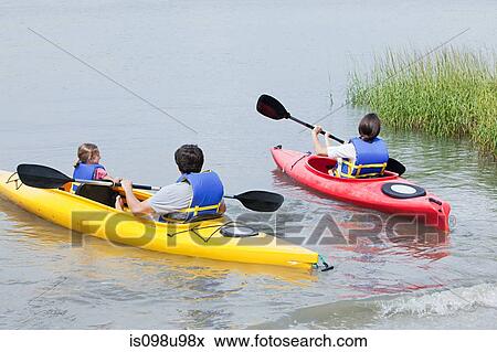 Couple and daughters kayaking View Large Photo Image Stock Photo - Couple and daughters kayaking. Fotosearch