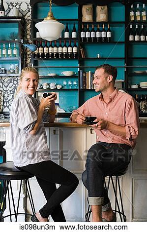 Picture - Couple at coffee bar. Fotosearch