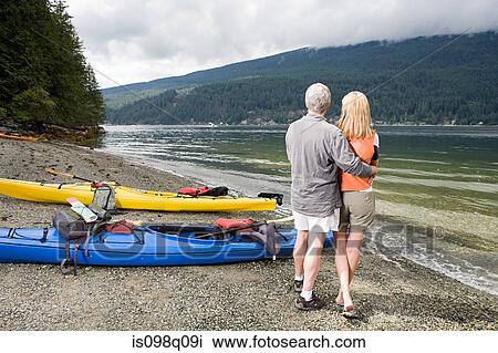 Stock Image - Couple by fjord. Fotosearch