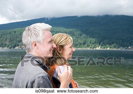 Couple by lake View Large Photo Image Stock Photograph - Couple by lake. Fotosearch
