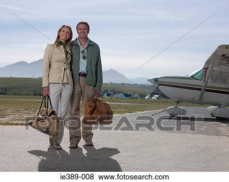 Stock Photo - Couple by private aeroplane. Fotosearch