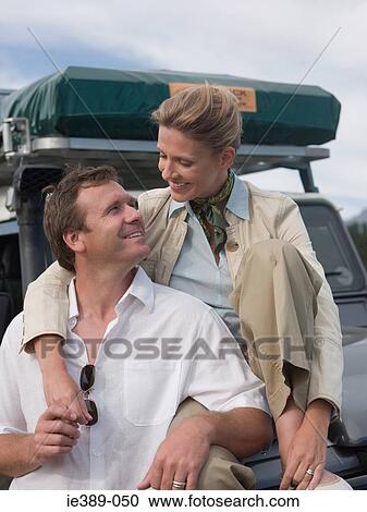 Couple by sports utility vehicle View Large Photo Image Stock Image - Couple by sports utility vehicle. Fotosearch