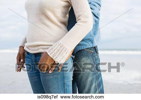 Stock Image - Couple by the sea. Fotosearch