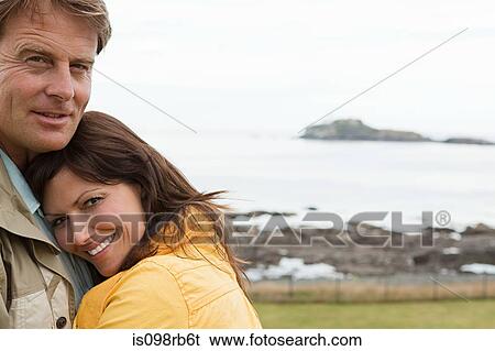 Couple by the sea View Large Photo Image Stock Photograph - Couple by the sea. Fotosearch