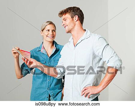 Couple choosing paint color View Large Photo Image Stock Photo - Couple choosing paint color. Fotosearch