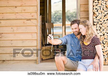 Couple enjoying lakeside vacation View Large Photo Image Picture - Couple enjoying lakeside vacation. Fotosearch
