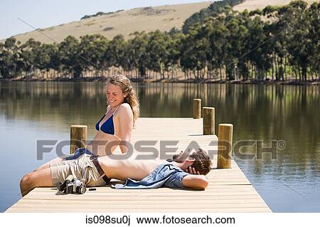Stock Image - Couple enjoying lakeside vacation. Fotosearch