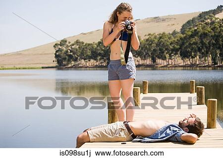 Stock Image - Couple enjoying lakeside vacation. Fotosearch