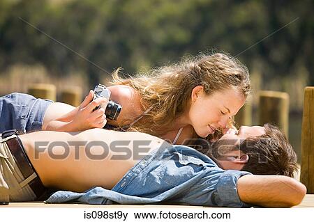 Stock Photo - Couple enjoying lakeside vacation. Fotosearch