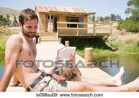Stock Photo - Couple enjoying lakeside vacation. Fotosearch