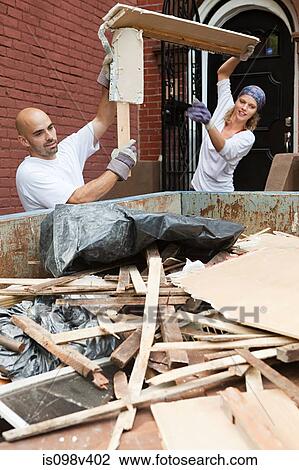 Couple filling skip with rubble View Large Photo Image Stock Image - Couple filling skip with rubble. Fotosearch