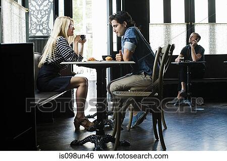 Couple having coffee in cafe View Large Photo Image Stock Photograph - Couple having coffee in cafe. Fotosearch
