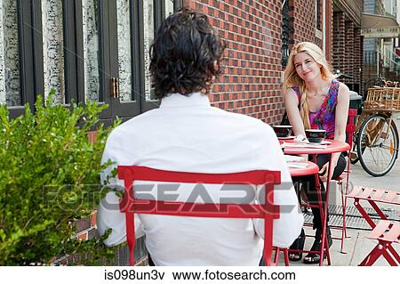 Stock Photo - Couple having coffee outside cafe. Fotosearch