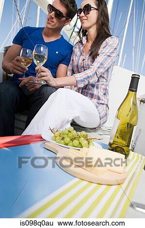 Stock Photograph - Couple having lunch on a boat. Fotosearch
