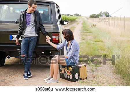 Couple holding hands by suv View Large Photo Image Stock Photograph - Couple holding hands by suv. Fotosearch