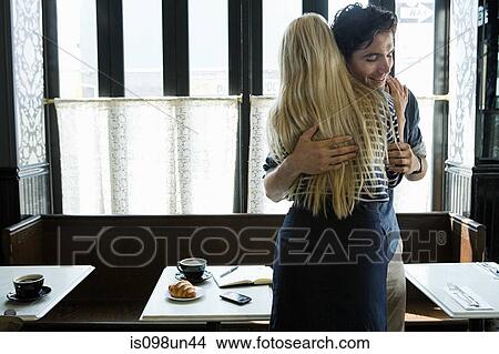 Couple hugging in cafe View Large Photo Image Picture - Couple hugging in cafe. Fotosearch