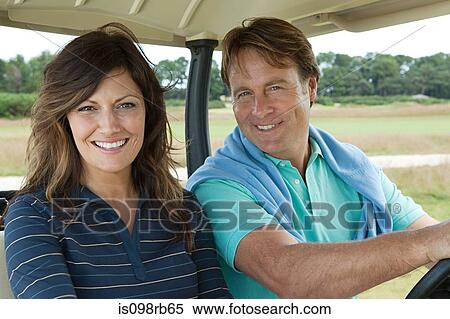 Stock Photography - Couple in golf cart. Fotosearch