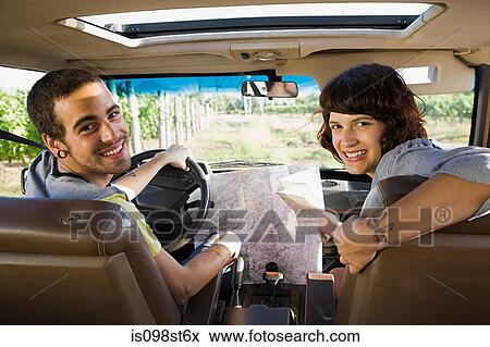Stock Photo - Couple in vehicle with map. Fotosearch