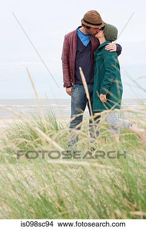 Couple kissing at the coast View Large Photo Image Picture - Couple kissing at the coast. Fotosearch