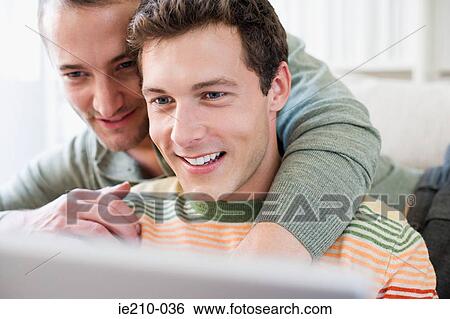Stock Photograph - Couple looking at laptop. Fotosearch