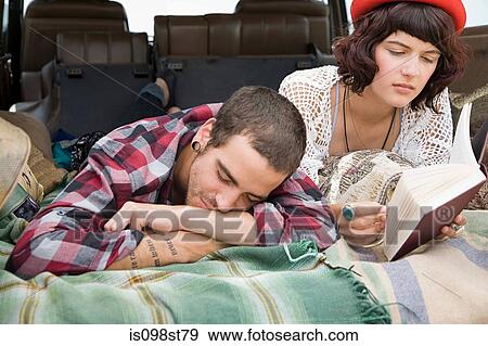 Couple lying in back of suv View Large Photo Image Stock Photo - Couple lying in back of suv. Fotosearch