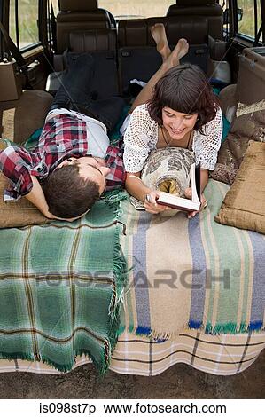 Couple lying in back of suv View Large Photo Image Stock Photography - Couple lying in back of suv. Fotosearch
