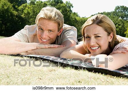 Couple lying on blanket View Large Photo Image Picture - Couple lying on blanket. Fotosearch