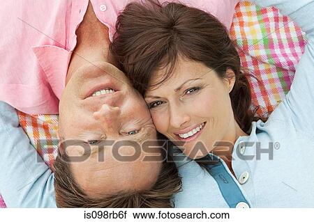 Stock Image - Couple lying on blanket. Fotosearch
