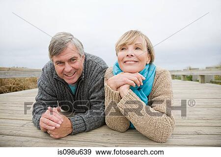 Couple lying on walkway View Large Photo Image Stock Photo - Couple lying on walkway. Fotosearch