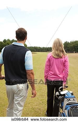 Picture - Couple of golfers on the fairway. Fotosearch