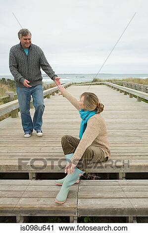 Couple on a coastal walkway View Large Photo Image Stock Image - Couple on a coastal walkway. Fotosearch
