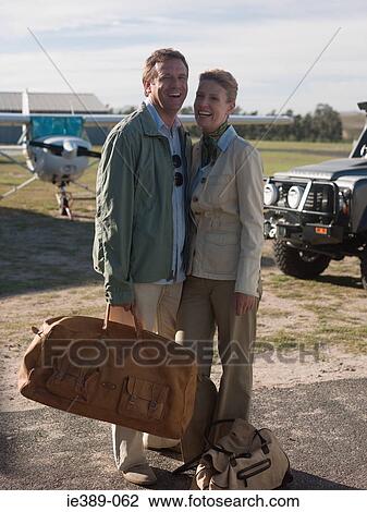Stock Image - Couple on airfield. Fotosearch