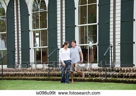 Couple outdoors by building View Large Photo Image Stock Photograph - Couple outdoors by building. Fotosearch