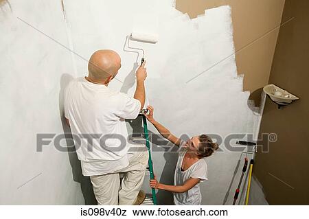 Stock Photo - Couple painting wall. Fotosearch