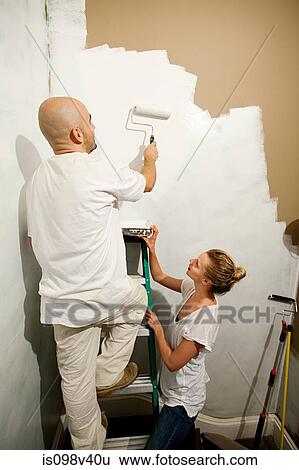 Couple painting wall View Large Photo Image Stock Photograph - Couple painting wall. Fotosearch