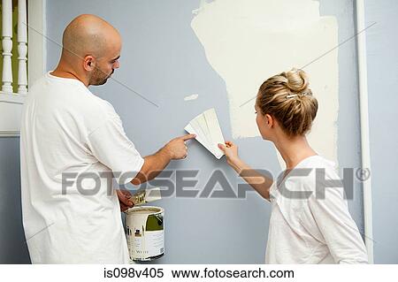 Stock Photography - Couple painting wall. Fotosearch