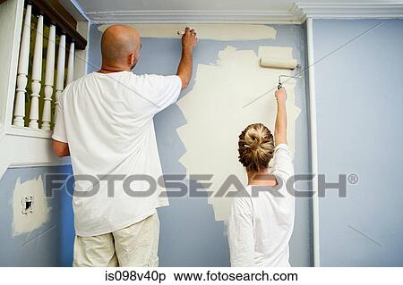 Stock Photography - Couple painting wall. Fotosearch