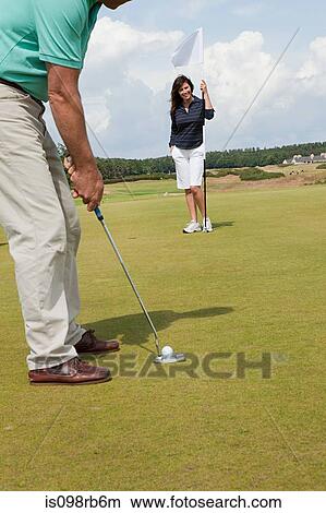 Picture - Couple playing golf. Fotosearch