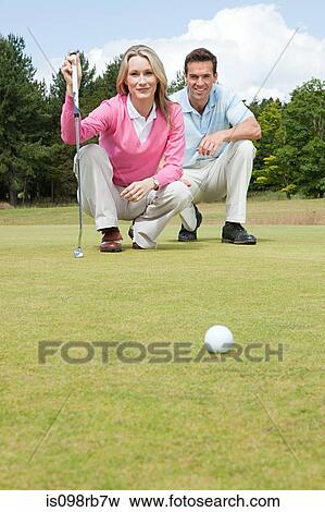 Couple playing golf View Large Photo Image Stock Photo - Couple playing golf. Fotosearch
