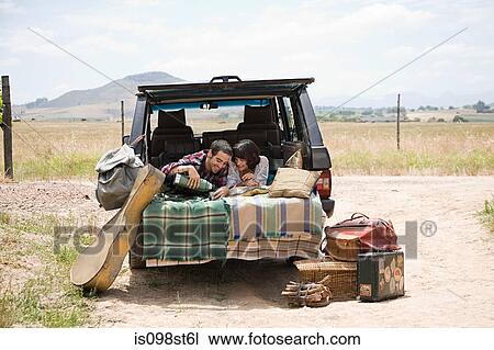 Couple relaxing in back of suv View Large Photo Image Stock Image - Couple relaxing in back of suv. Fotosearch