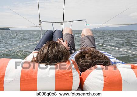 Stock Photo - Couple relaxing on a boat. Fotosearch