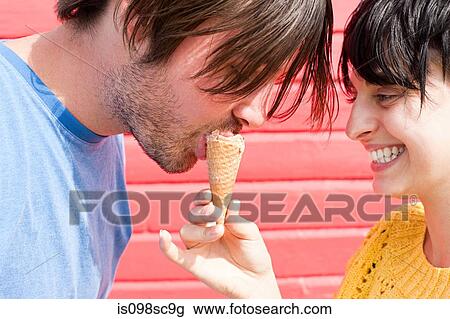 Couple sharing an ice cream View Large Photo Image Stock Image - Couple sharing an ice cream. Fotosearch