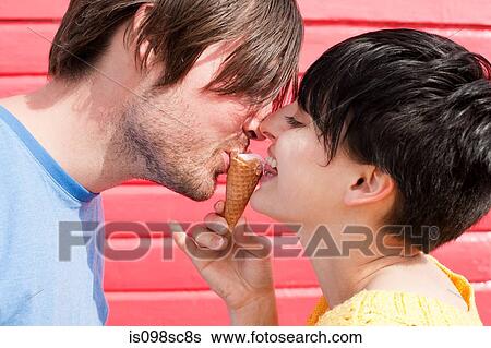 Stock Photograph - Couple sharing an ice cream. Fotosearch